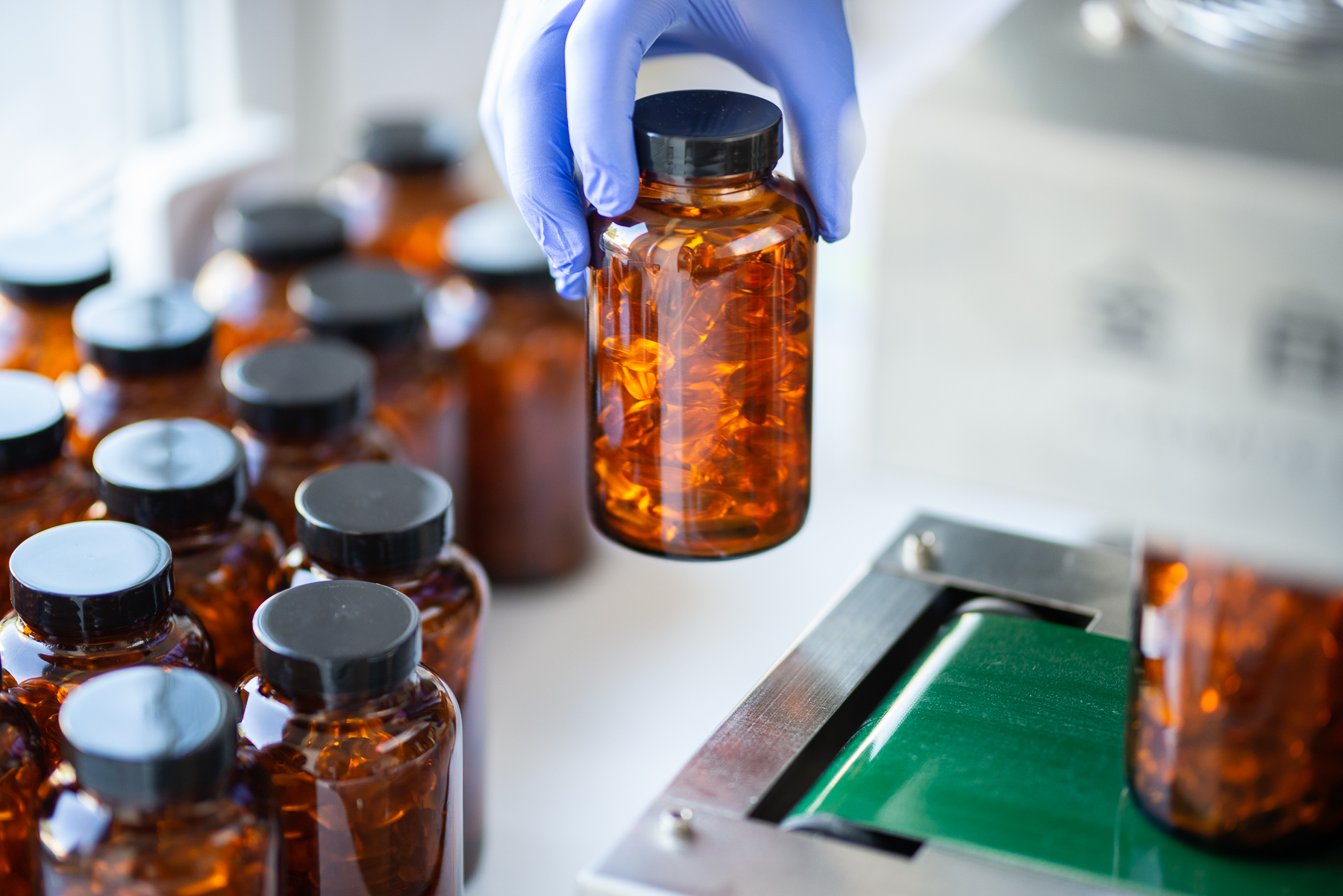 Amber bottles filled with capsules during packaging
