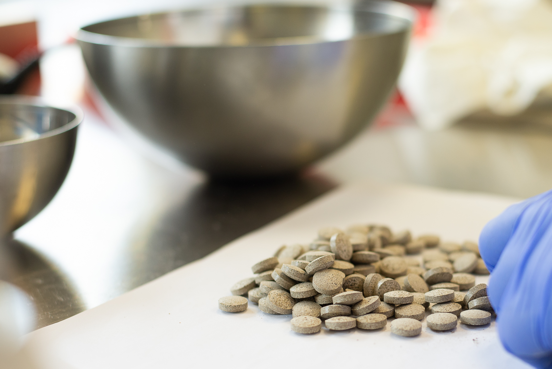 Compressed food supplement tablets in production